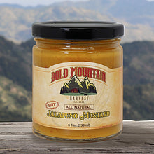 Load image into Gallery viewer, Bold Mountain Harvest Jalepeno Mustard in and 8-ounce jar in front of a mountain view. The mustard is marked with the word hot.